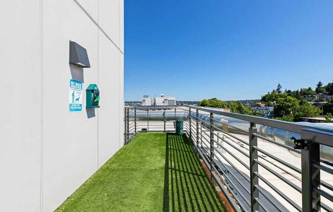 A white wall with a green sign and a small window.