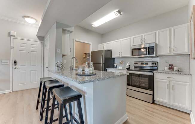 A kitchen with a bar area and stools.