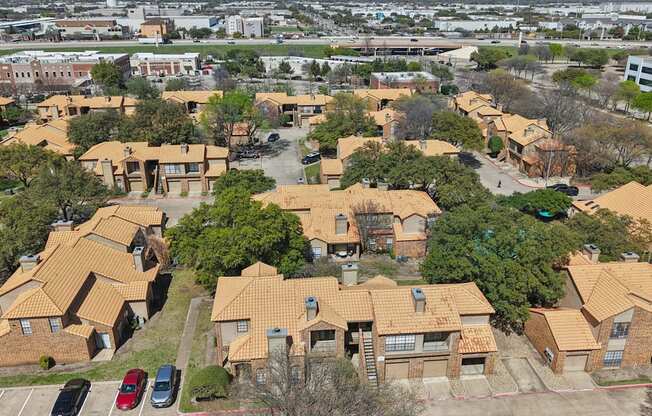 A bird's eye view of a residential area with houses and cars.