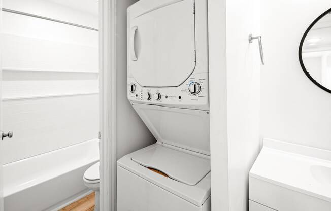 a small bathroom with a washer and dryer in it at The Courts Midtown, Memphis, TN, 38104