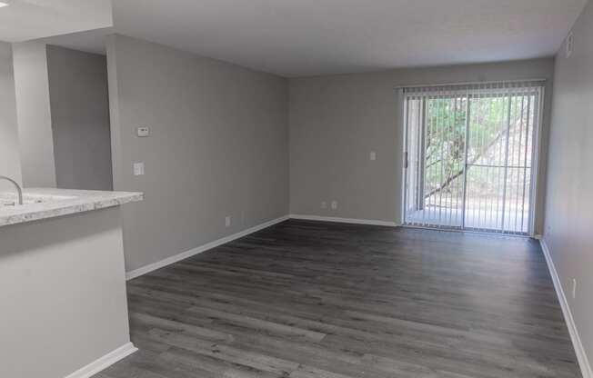 an empty living room with a sliding glass door