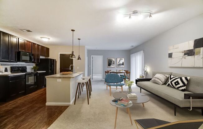 a living room with a couch and a kitchen