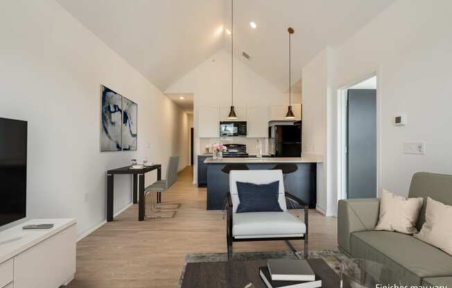 a view from the living room into the kitchen and dining area