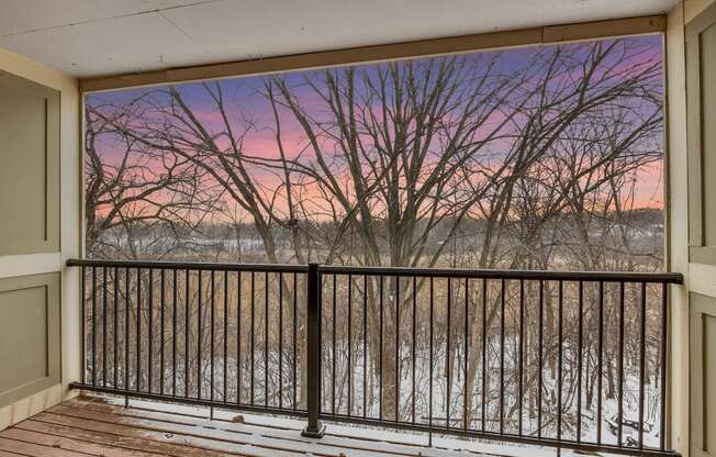 Stratford Wood Apartments and Townhomes in Minnetonka, MN Photo of a balcony with a view of a river at sunset