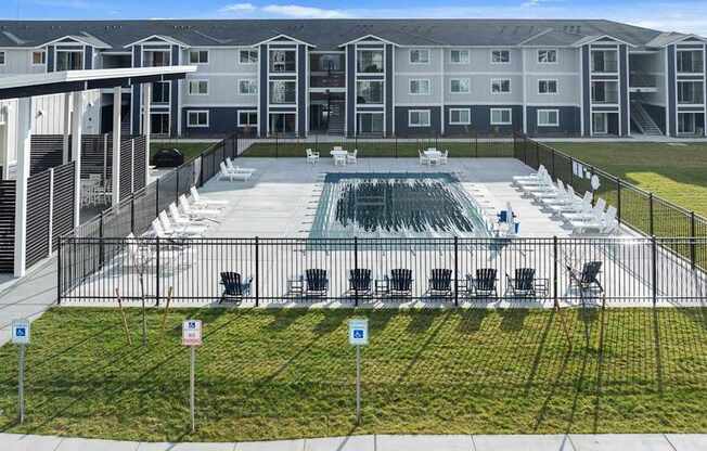 A large building with a pool in front.