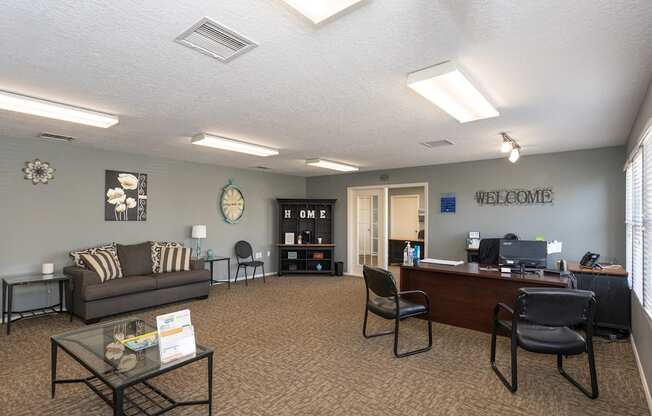 A living room with a couch, chairs, and a coffee table.