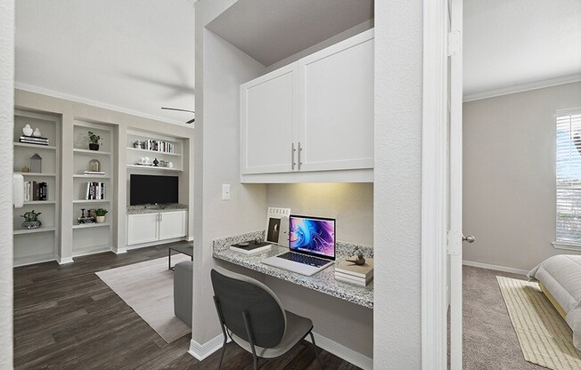 Model Office Area with Wood-Style Flooring and Built in Desk at Chapel Hill Apartments in Lewisville, TX.