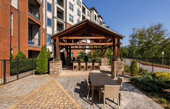 a patio with a table and chairs outside of an apartment building