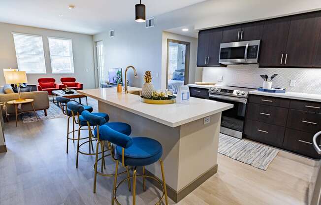 furnished kitchen with stool seating at Bayswater Apartments, California