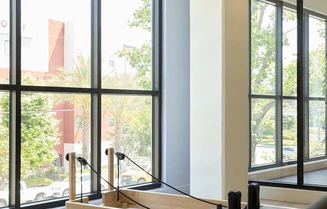 A pilates reformer in a room with a view of the outdoors.