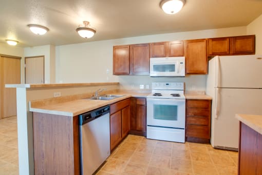 a kitchen with white appliances and wooden cabinets
