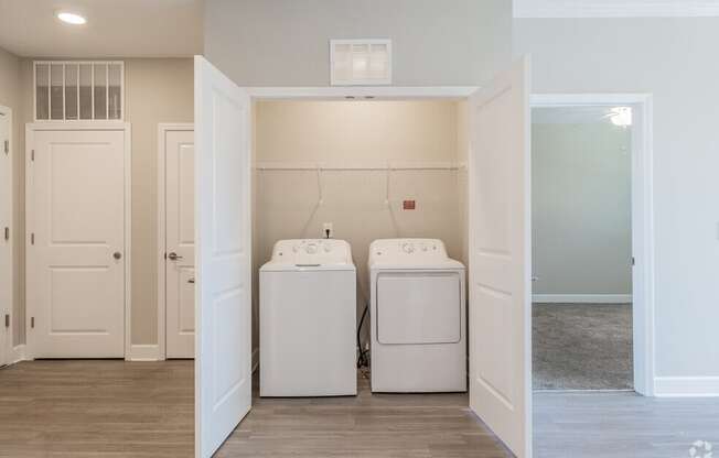 a laundry room with two washer and dryers in it