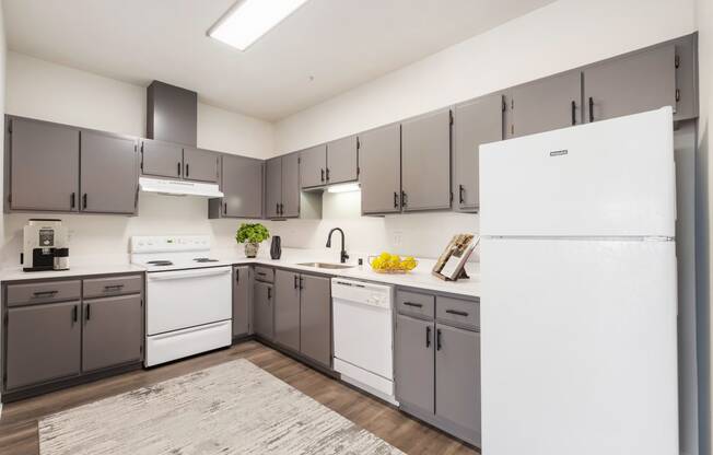 Large kitchen with full-size fridge, a dishwasher, sink, oven, stovetop and range hood.at Shoreline Village, Richland, WA 99352