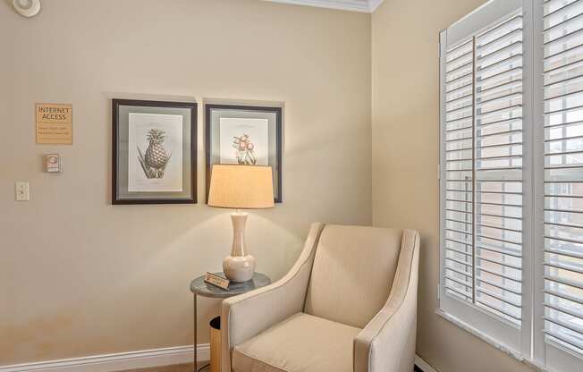 a living room with a chair and a lamp