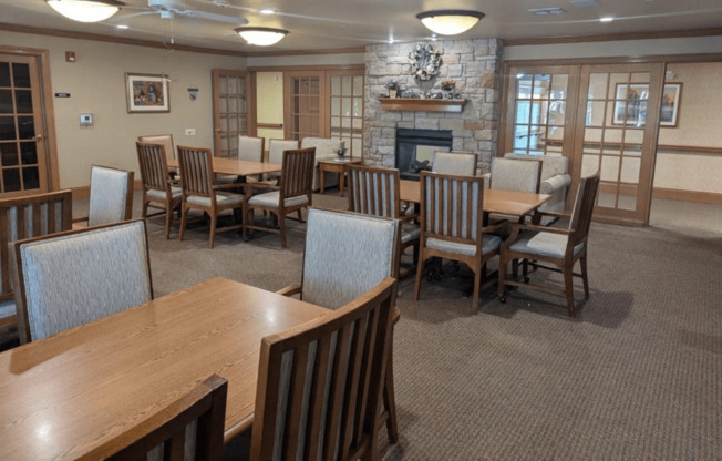 a dining room with tables and chairs and a fireplace