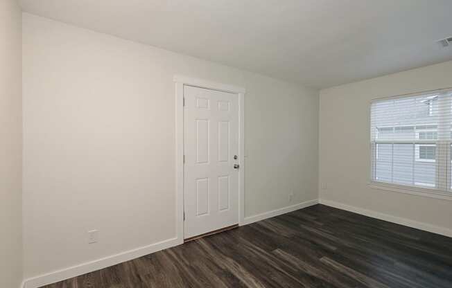 a bedroom with hardwood floors and white walls at Bennett Ridge Apartments, Oklahoma City, Oklahoma