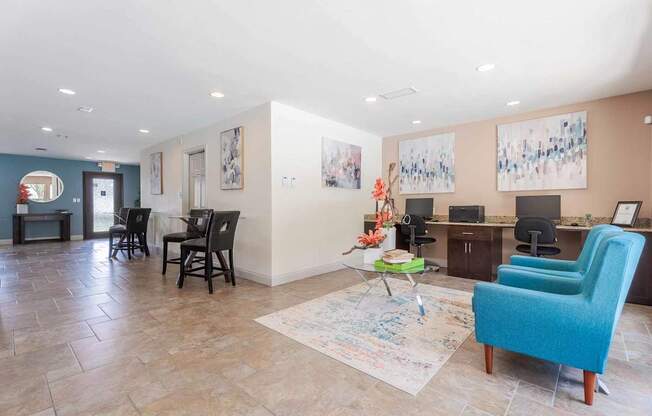 A living room with a blue chair and a rug with a drawing on it.