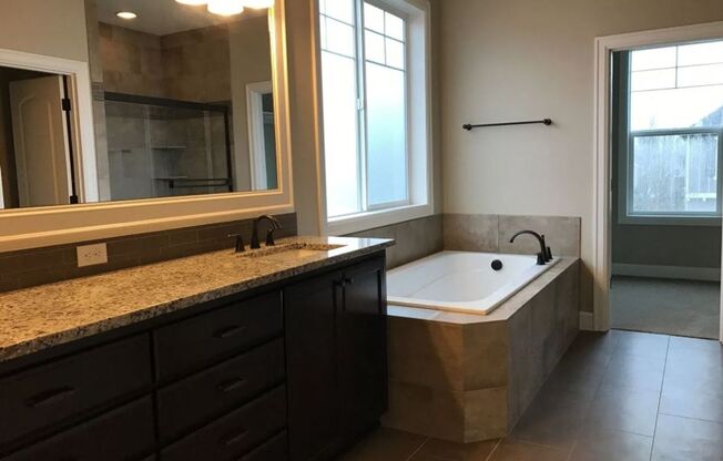 Stylish 5-Bedroom Home with Modern Kitchen, Stone Fireplace & Luxurious Primary Suite