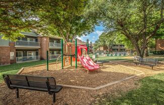 a bench in front of a tree