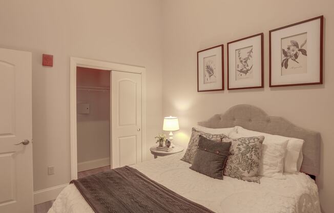 a bedroom with a bed and some pictures on the wall