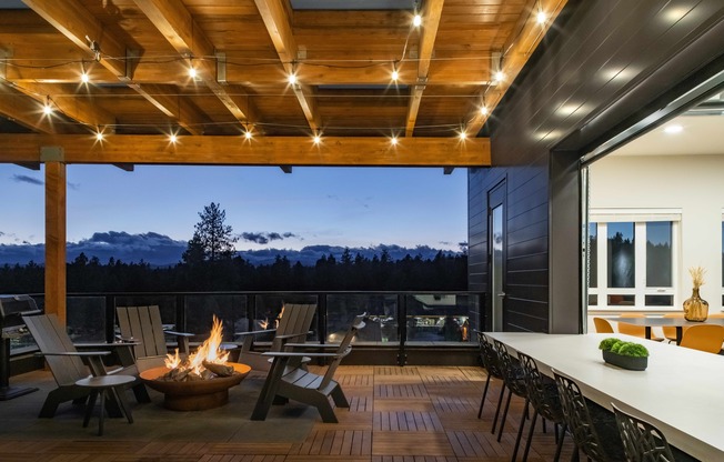 fire pit and rooftop deck at dusk at The Hixon as well as indoor-outdoor space