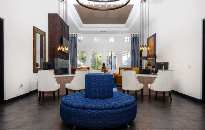 a living room with a blue chair and a table with chairs