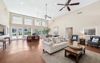 A living room with a white couch and a coffee table.