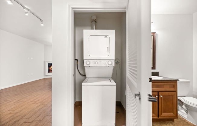 a white washer and dryer in a small room in a house