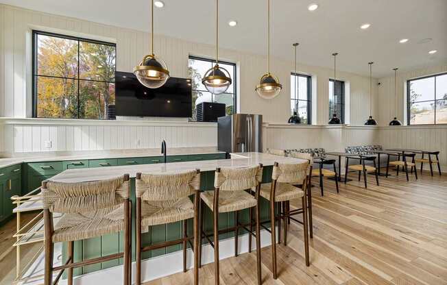 A kitchen with wooden floors and green backsplash.