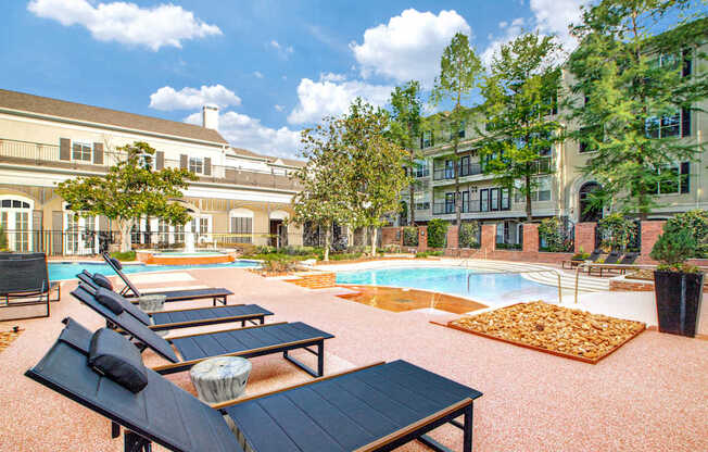 A pool area with sun loungers and a table.