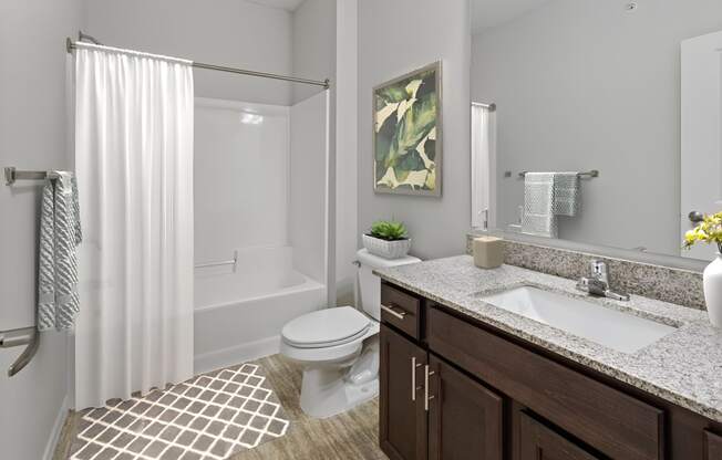 a bathroom with a toilet and a sink and a shower