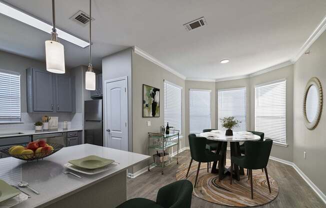 A kitchen with a table and chairs in the middle of the room.