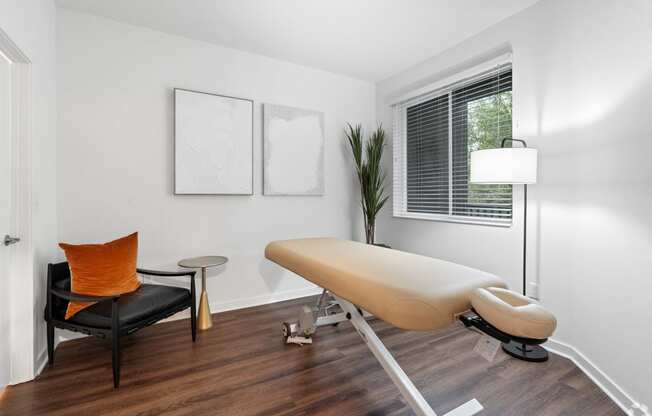 an office with a white table and chair and a window