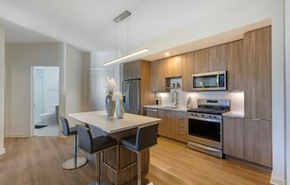 A modern kitchen with a dining table and chairs.