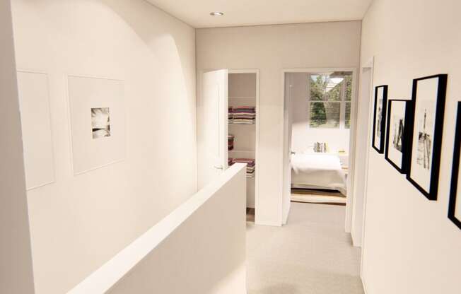 a long white hallway with pictures on the wall at Brownstones at Palisade Park, Colorado, 80023