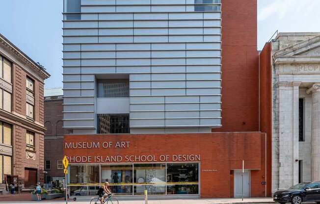A modern building with a red brick building in front of it.