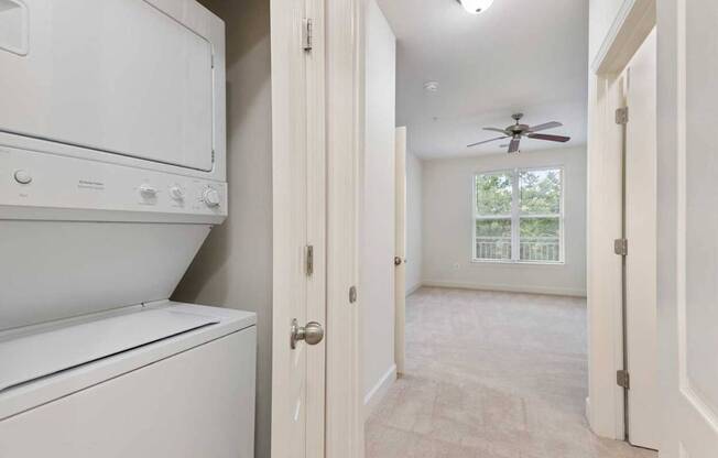 an empty laundry room with a washer and dryer