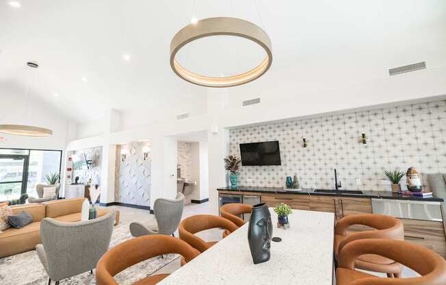 A modern dining area with a white table and chairs.