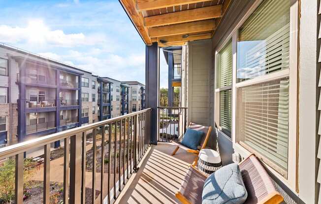 A balcony with a bench and pillow on it