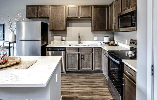 Spacious kitchen with dark wood cabinets at Sterling at Prairie Trail in Ankeny, IA