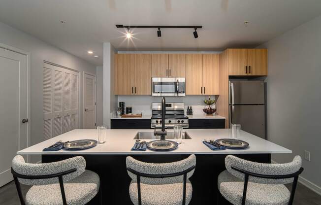 a kitchen with a large island with a table and chairs