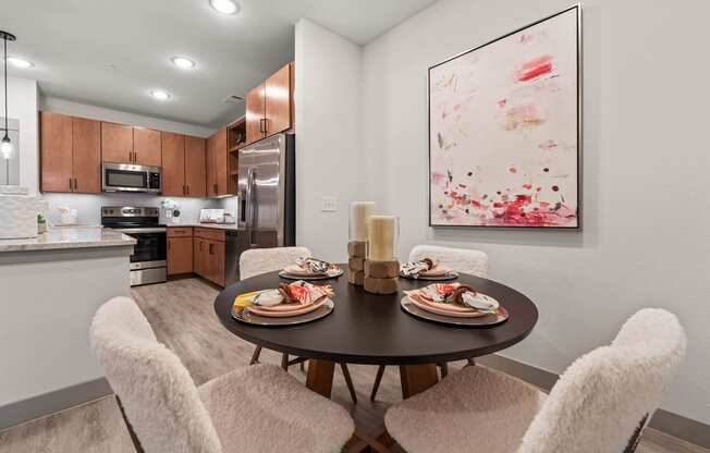 a kitchen and dining room with a table and chairs