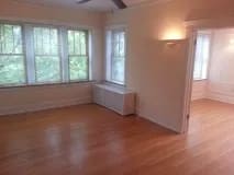 Living room with a wooden floor and windows at Bryant II