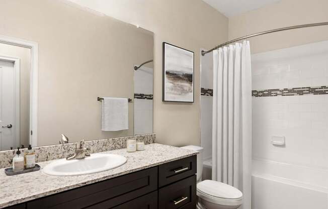 A bathroom with a white toilet and a white shower curtain.