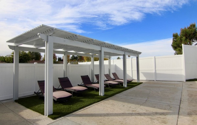 Pool lounging area with gazebo room for at least 5 people.