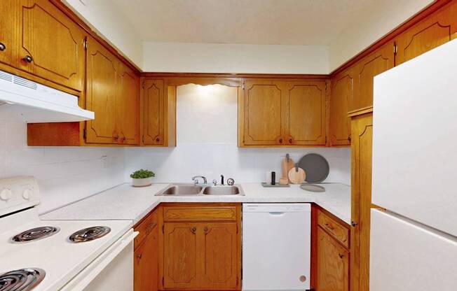 A kitchen with wooden cabinets and white appliances.