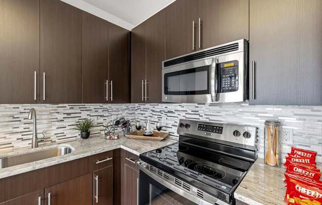 A modern kitchen with a stainless steel oven and microwave.
