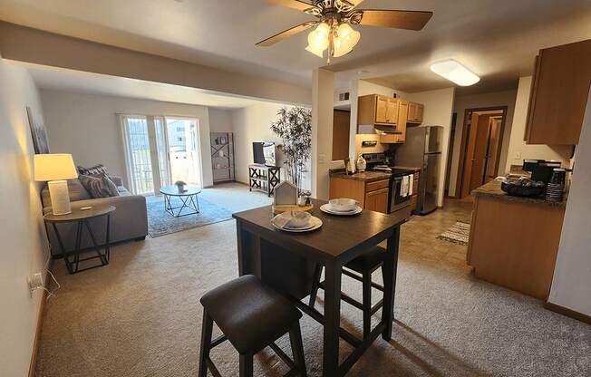 A living room with a dining table and chairs.