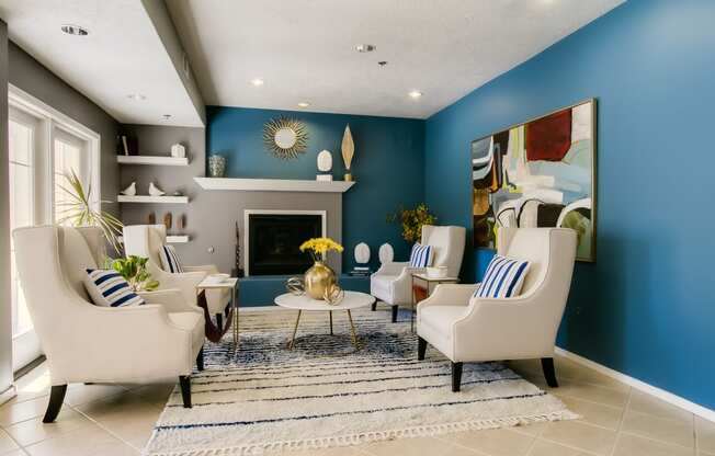 a living room with blue walls and a white tile floor