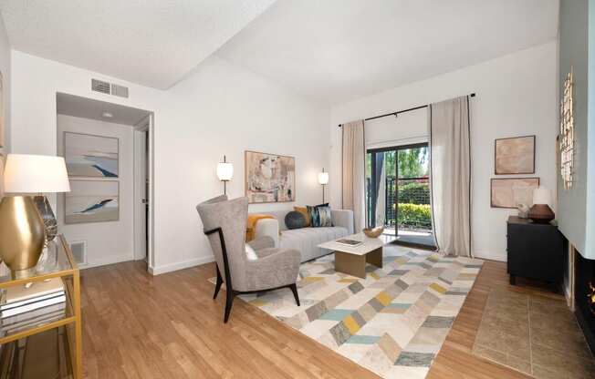 a living room with hardwood floors and a sliding glass door